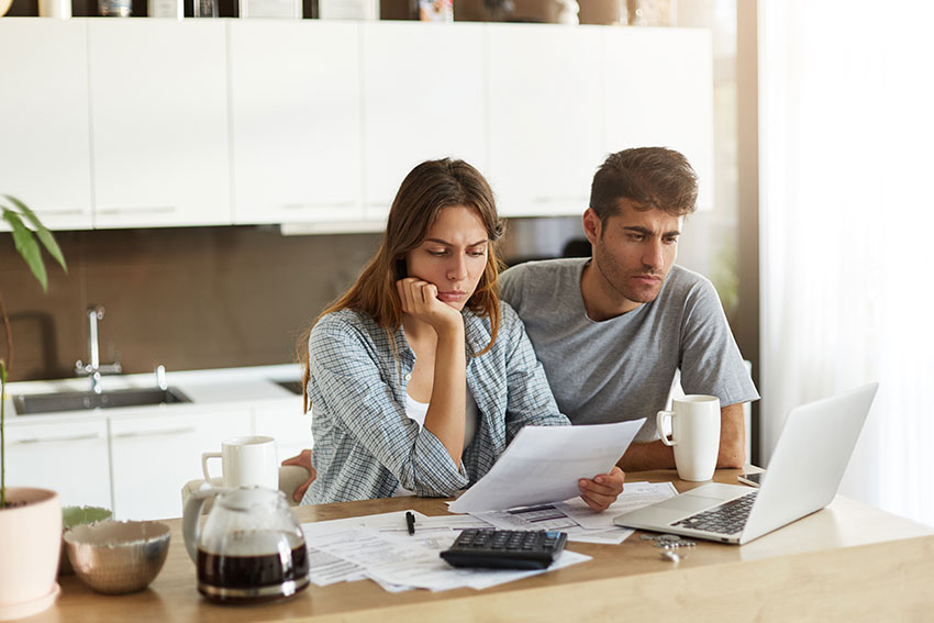 photo of a divorcing couple preparing their financial documents to disclose to their collaborative divorce lawyer to speed up their divorce